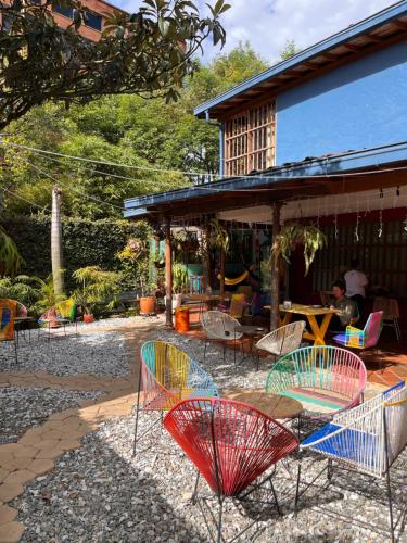 a group of chairs and tables in a yard at Yolo Hostel Medellin in Medellín