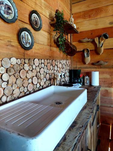 a large white tub in a kitchen with wooden walls at Cabane insolite TOUT CONFORT Chalet Gites Luzy Morvan Bourgogne in Luzy