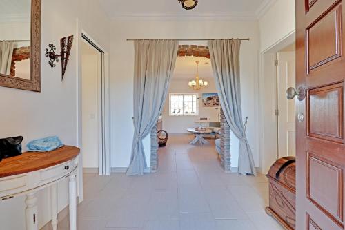 a hallway with a door leading to a living room at Casa de Apra by Portucasa in Loulé
