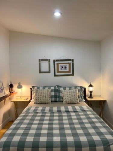 a bedroom with a bed with a checkered blanket at Island House Rentals 48 in Ko Samed