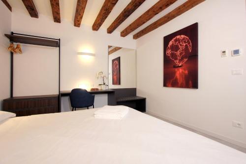 a bedroom with a white bed and a desk at Residence Modern Art in Venice