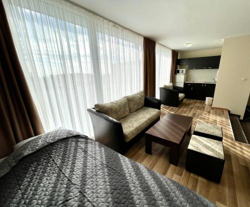 a hotel room with a bed and a living room at BSA Gradina Hotel & Aquapark - All Inclusive in Golden Sands