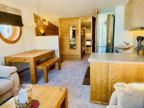 a kitchen and a living room with a table at Luxury Chalet with sauna by Avoriaz Chalets in Avoriaz