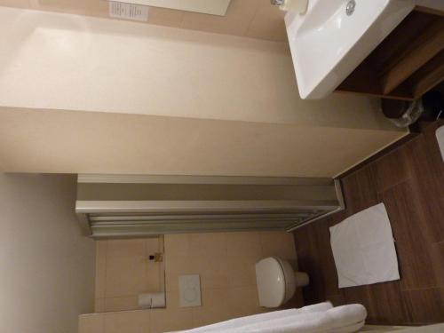 a mirror in a room with a bed and a sink at Pension Mühle in Zell am See