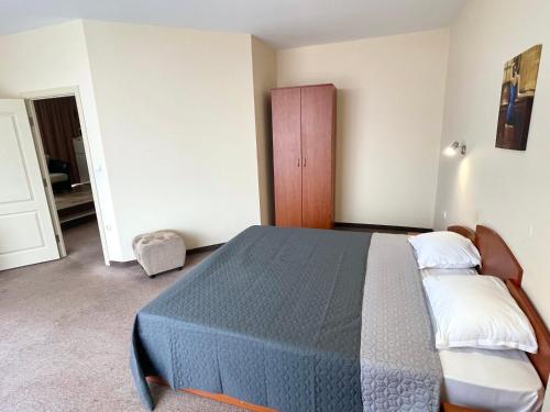 a bedroom with a blue bed in a room at BSA Gradina Hotel & Aquapark - All Inclusive in Golden Sands