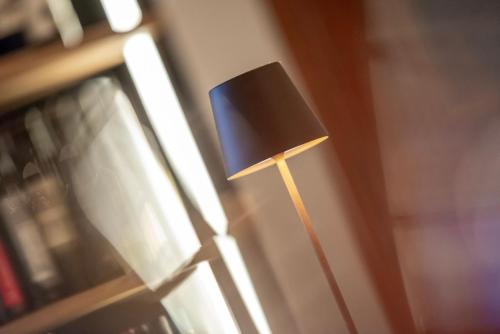 a small black lamp sitting next to a window at Hotel Bellevue in San Bernardino