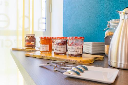 a counter with three jars of food on a table at Appart'City Classic Bourg-en-Bresse in Bourg-en-Bresse