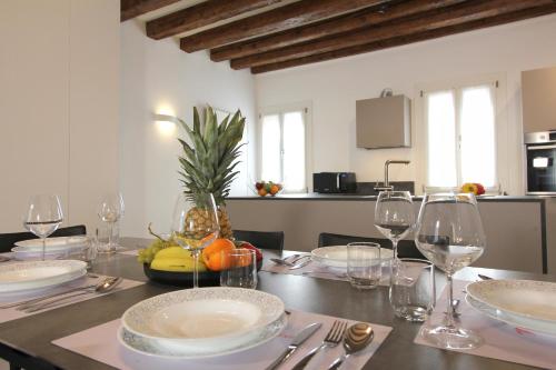 a dining room table with plates and wine glasses at Residence Modern Art in Venice