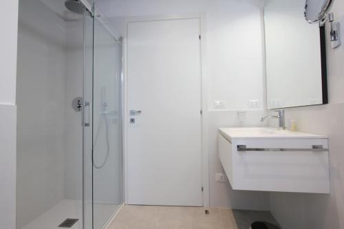 a white bathroom with a sink and a shower at Residence Modern Art in Venice