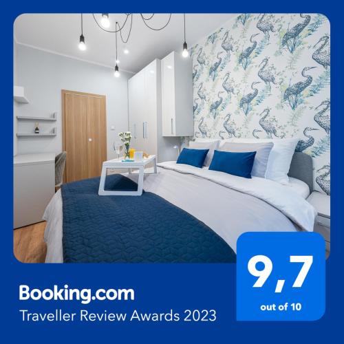 a bedroom with a large bed with a mural of dragons at Apartment BlueBird Katowice near Spodek MCK & City Center in Katowice