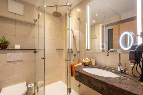 a bathroom with a sink and a shower at Hotel Alpspitz B&B in Grainau