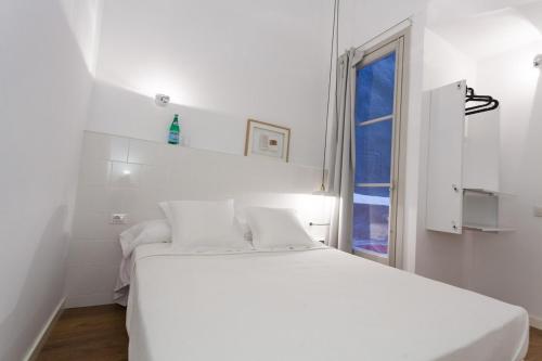 Кровать или кровати в номере Hostal Argo