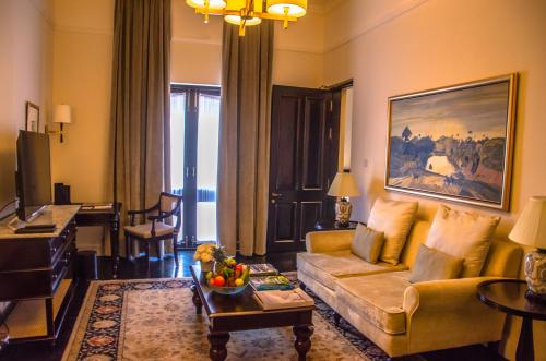a living room with a couch and a table at Galle Face Hotel in Colombo