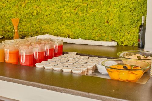 a group of cups and bowls on a counter at Club Esse Roccaruja in Stintino