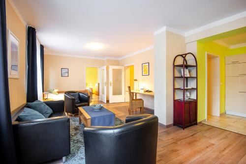 a living room with two couches and a table at City Hotel in Geilenkirchen