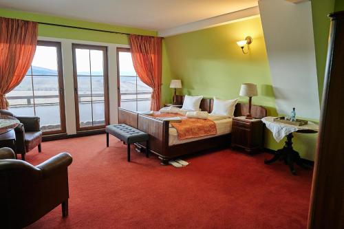 a hotel room with a bed and a balcony at Saciova Hills in Saciova