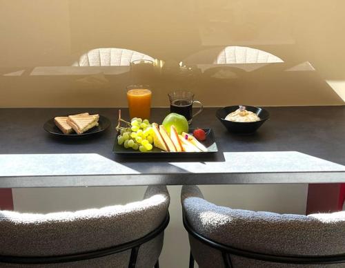 a table with a plate of food and fruit on it at Acropolis View Apartment Athens Downtown in Athens