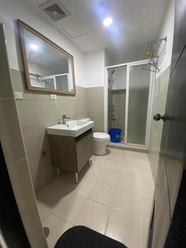 a bathroom with a sink and a toilet and a mirror at 88Minesview LODGE By SUNTRUST CONDOMINIUM in Baguio