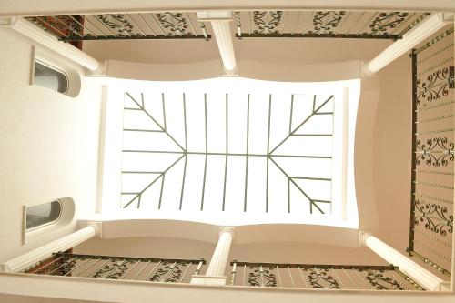 a large window in a room with a staircase at Hostal Puerto Lepe in Lepe