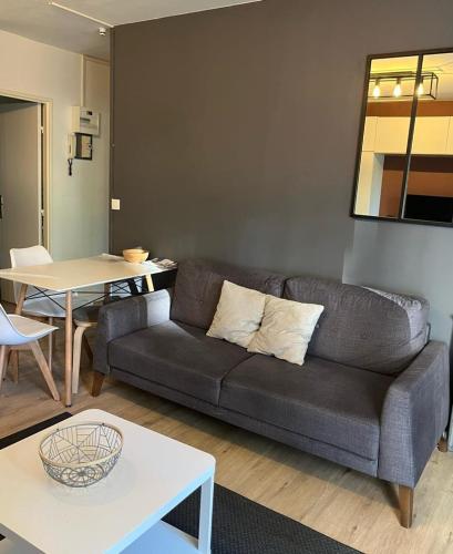 sala de estar con sofá y mesa en APPARTEMENT 190, en Évreux