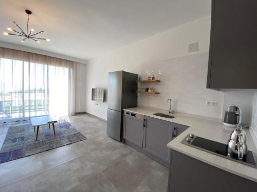 a kitchen with a stainless steel refrigerator and a table at Hemera Suite in Kas