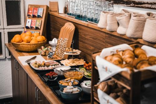 a buffet with a lot of food on a table at Hotel Guesthouse Dalnig in Bad Kleinkirchheim
