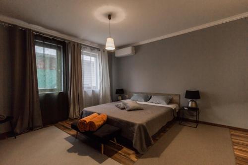 a bedroom with a bed and a large window at Casa Lavenda in Plovdiv