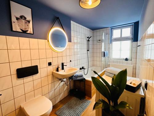 uma casa de banho com um lavatório, um WC e um espelho. em Apartments Dombergblick - Suhl, Stadtmitte em Suhl