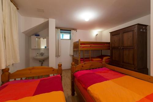 a bedroom with two bunk beds and a sink at House Jelenko in Bovec