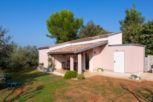 a large white house with a yard at Matija in Ližnjan