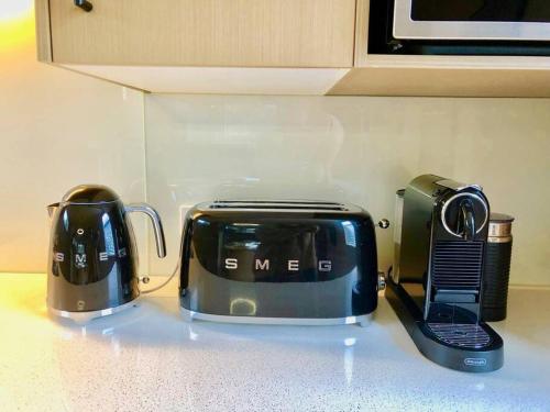 a toaster and coffee maker on a kitchen counter at Hepburn Hideaway Villa ~ Hepburn / Daylesford in Hepburn Springs