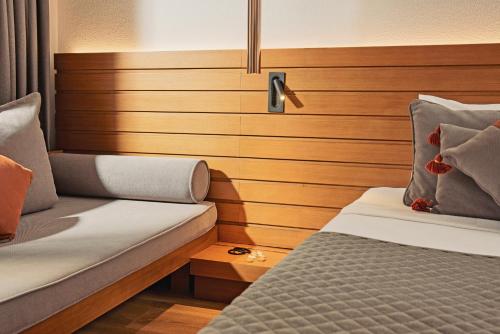 a bedroom with two beds and a wooden headboard at TUI MAGIC LIFE Sarigerme in Sarigerme