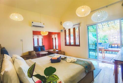 a room with a bed and a couch in it at Varni Homestay in Phatthalung
