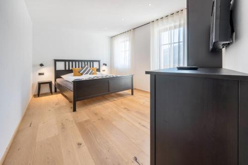 a bedroom with a bed and a large window at Binderhof Apt Untn in Brixen