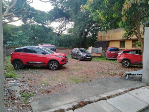 a group of parked cars parked in a yard at Le Prince Villa STAY with CAR PARKING in Pondicherry