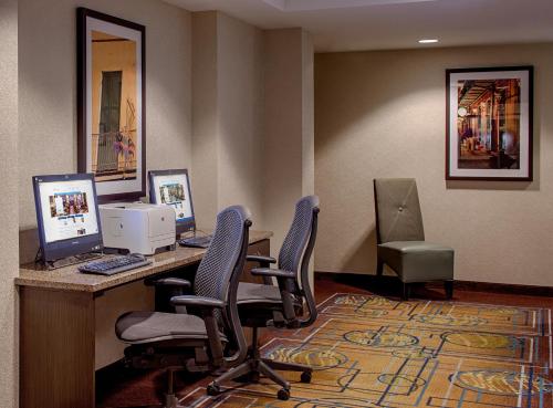 an office with two computers on a desk with chairs at Wyndham New Orleans French Quarter in New Orleans