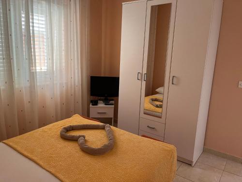 a snake on a bed in a bedroom at Apartments Pralija in Sevid
