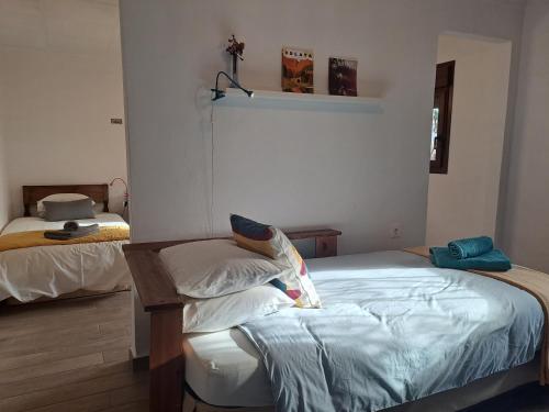 a bedroom with a bed with pillows on it at Casa Champasak in Órgiva