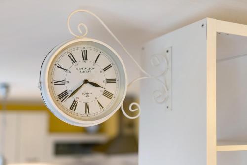 a clock that is hanging on a wall at Il giardino di Belgirate in Belgirate