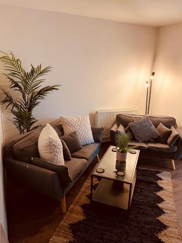 a living room with a couch and a coffee table at 'Woodbury' at stayBOOM in Lancaster