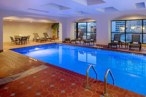 a pool in a hotel with tables and chairs at Wyndham New Orleans French Quarter in New Orleans