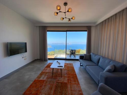 a living room with a blue couch and a table at Hemera Suite in Kas