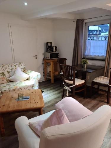 a living room with a couch and a table at Pilgrims Gästeapartements in Meschede