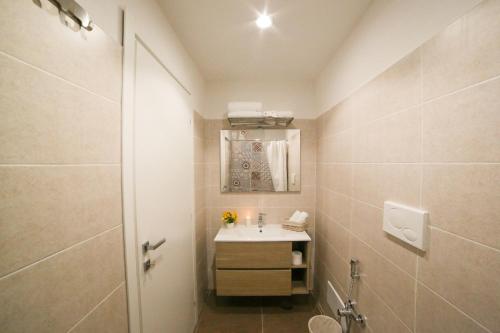un bagno con lavandino, WC e specchio di Casa Historical Center a Napoli