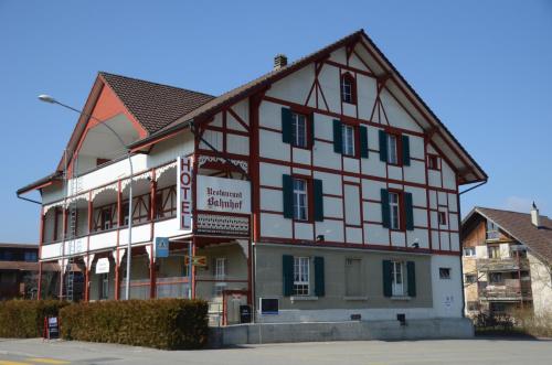 a large white and red building with aventh floor at Hotel Restaurant Bahnhof in Schüpfen