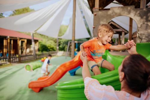 a woman playing with a child on a playground at TUI MAGIC LIFE Sarigerme in Sarigerme