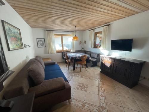 a living room with a couch and a table at Haus Wittig in Sankt Ulrich am Pillersee