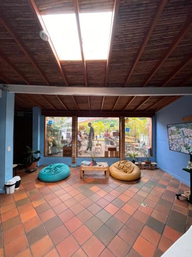 a living room with a large window and a table at Yolo Hostel Medellin in Medellín