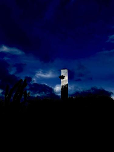a silhouette of a building on a hill with a bird at Kohinor maison d'hôtes in Douar Oulad ben Kheja