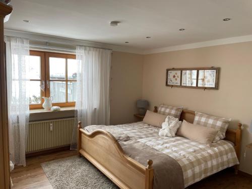 um quarto com uma cama e uma janela em Am Hörnle Appartements em Pfronten